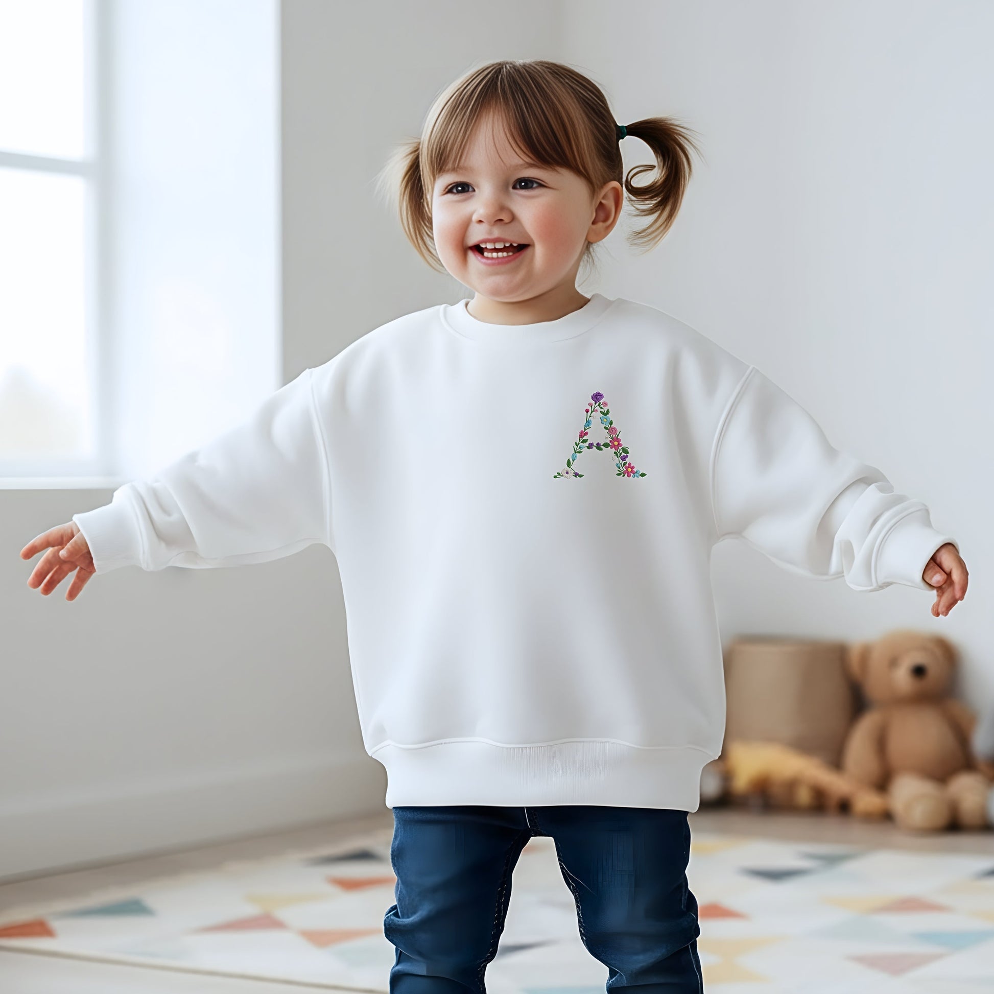 Floral initial embroidered sweatshirt: Floral initial girls sweatshirt featuring delicate embroidered flower letter design on soft kids jumper.