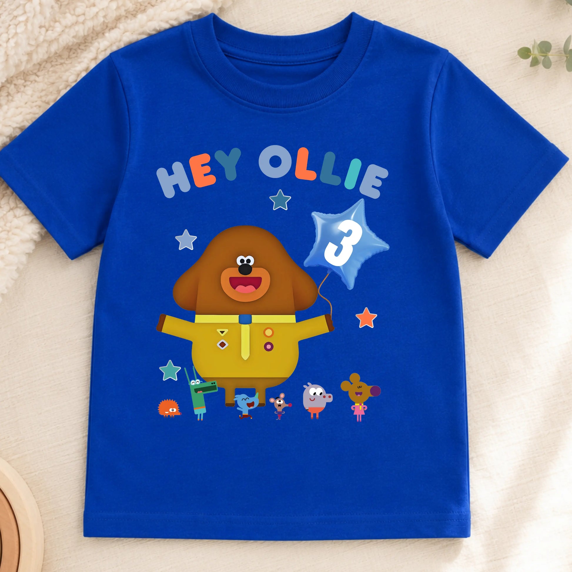 A personalised Hey Duggee kids birthday t-shirt featuring a colourful character design and the text "HEY Ollie" on the front.