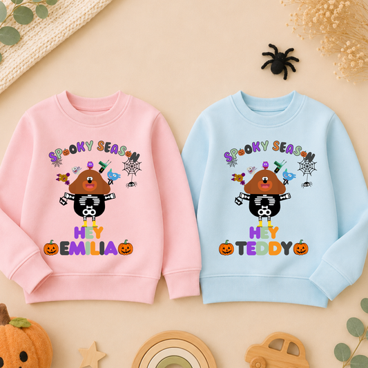 Flat lay of personalised Halloween sweatshirt with trick-or-treat, Spooky Season design and custom name custom name