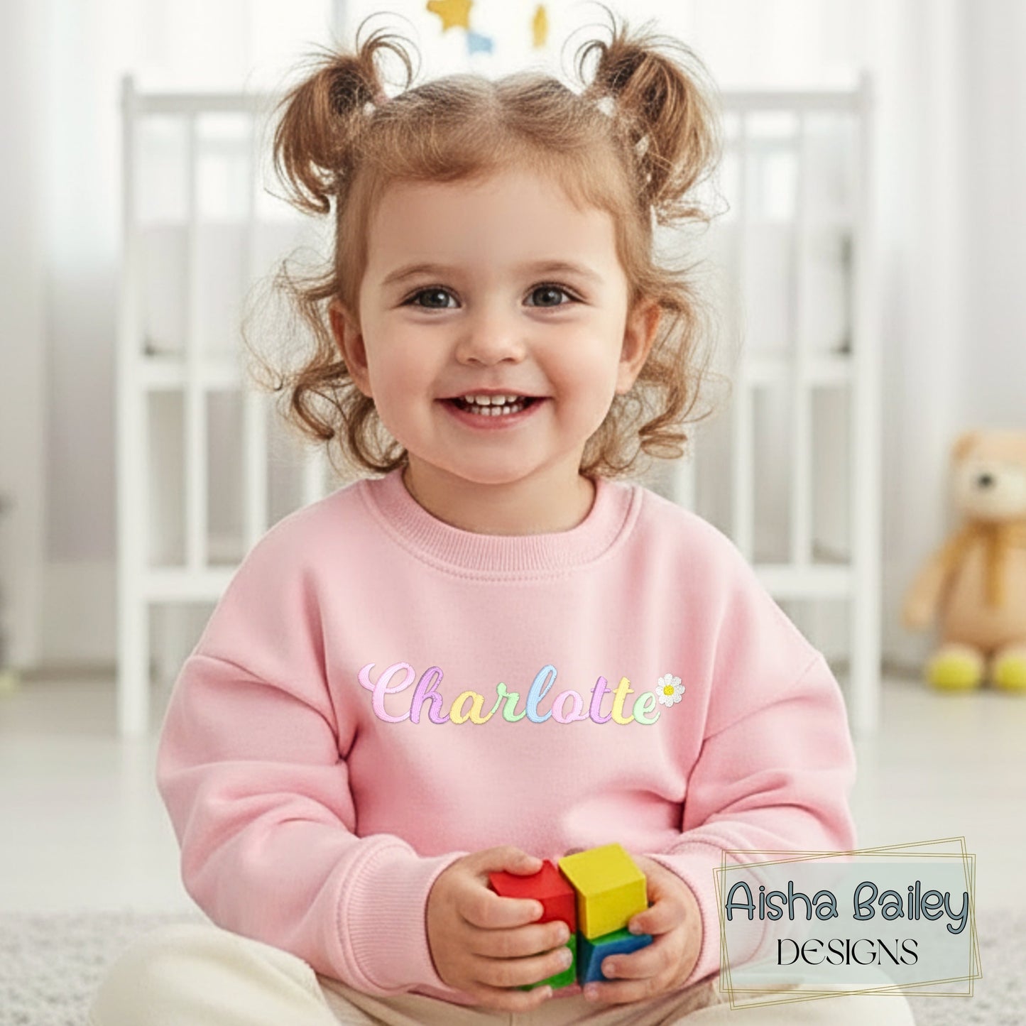 Girls personalised embroidered sweatshirt with custom name and pastal colours and daisy