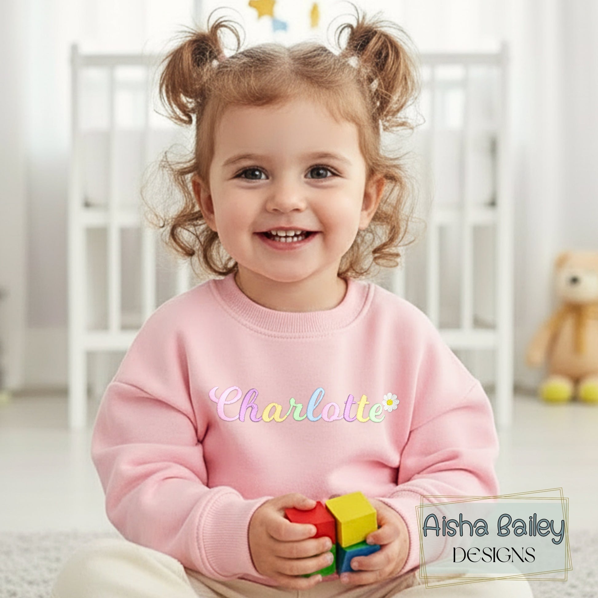 Girls personalised embroidered sweatshirt with custom name and pastal colours and daisy