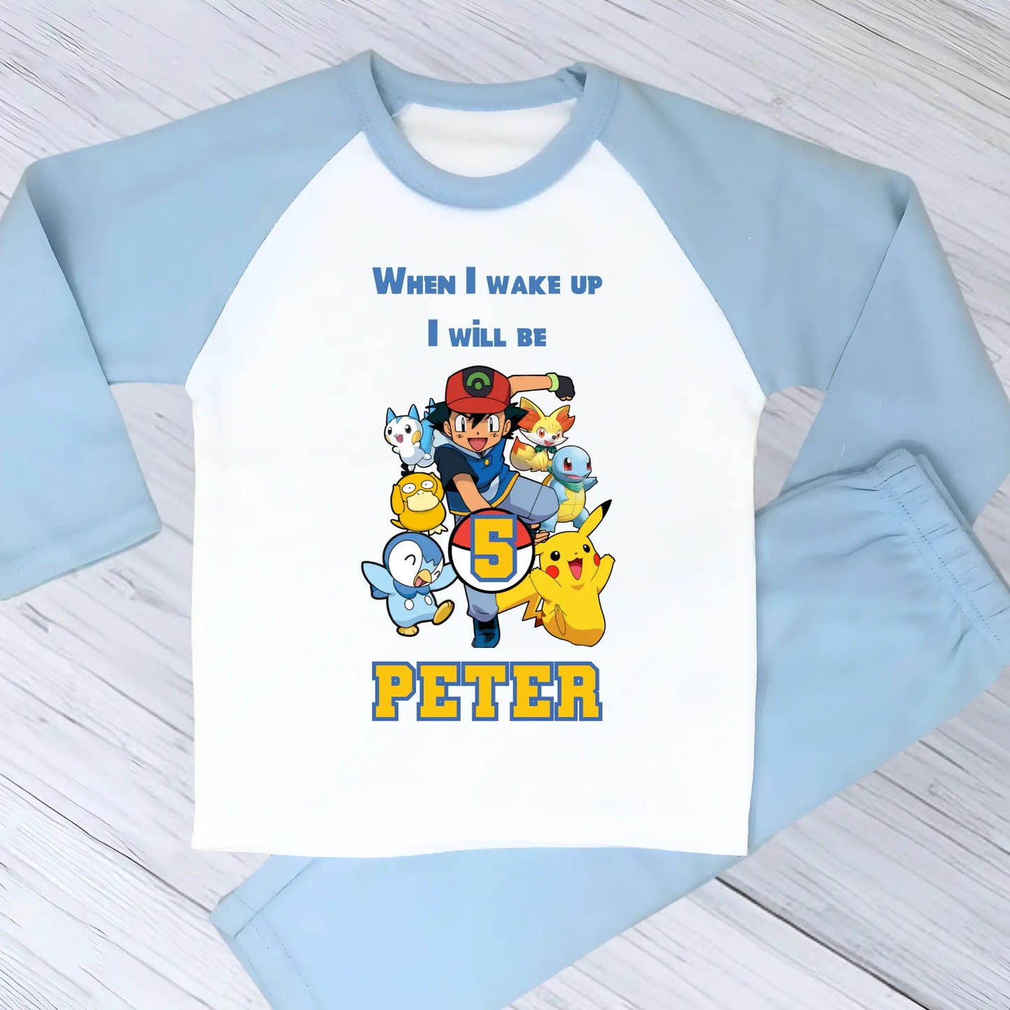 Pokomon birthday pyjamas: Children's PJst with Pokomon characters and text on a light blue and white background