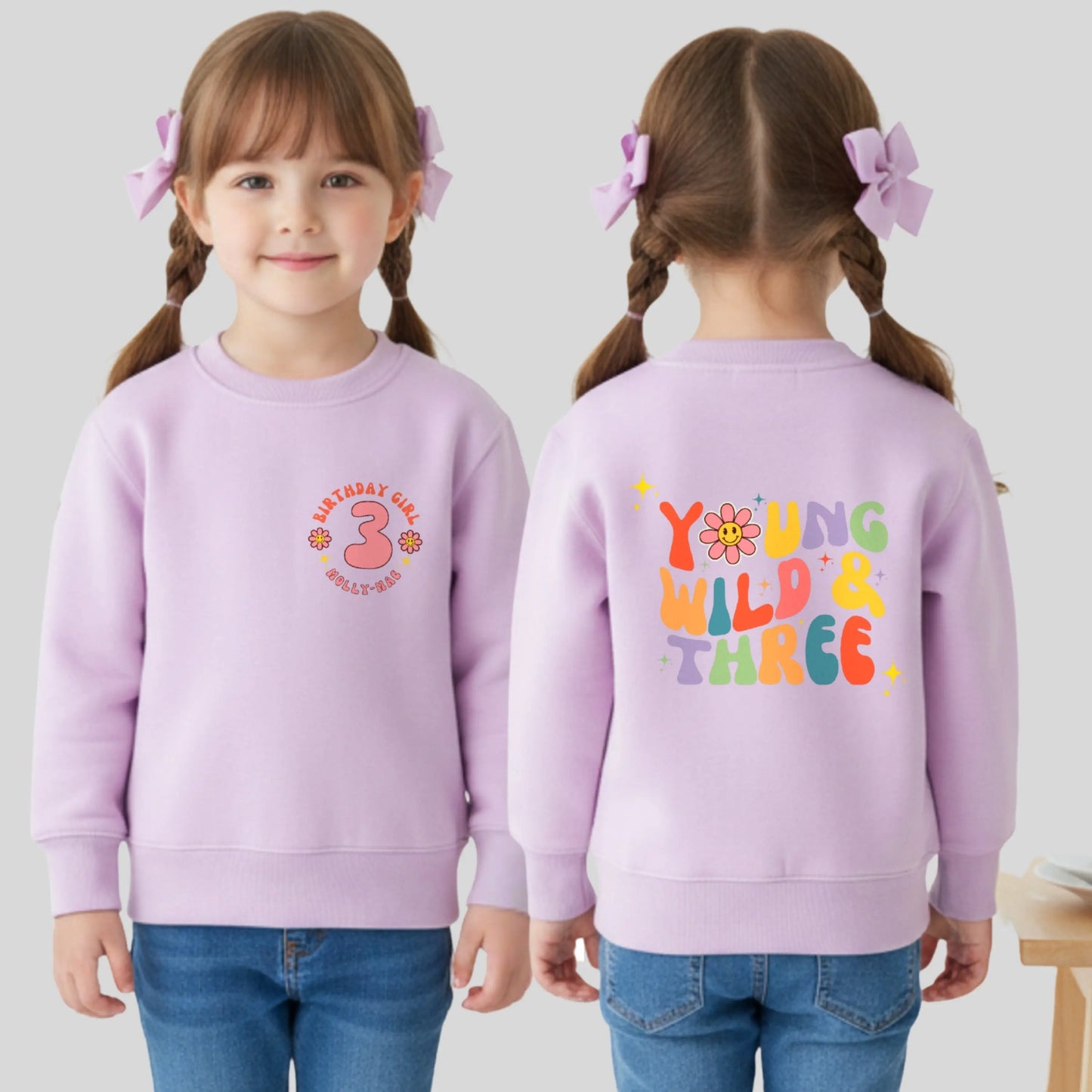 Girls Young Wild and Three birthday sweatshirt in groovy retro style, featuring birthday girl text, retro emojis, a personalised name on the front and bold nostalgic graphics on the back