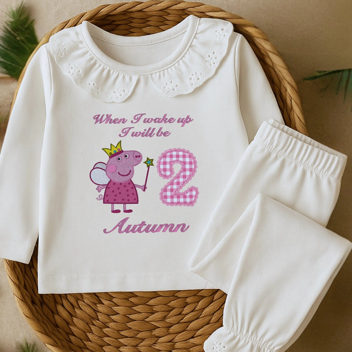Embroidered Peppa Pig Pyjamas: A flat lay of white frilly pyjamas with a Peppa Pig design with child's name under. Perfect for Christmas and birthday gifting.