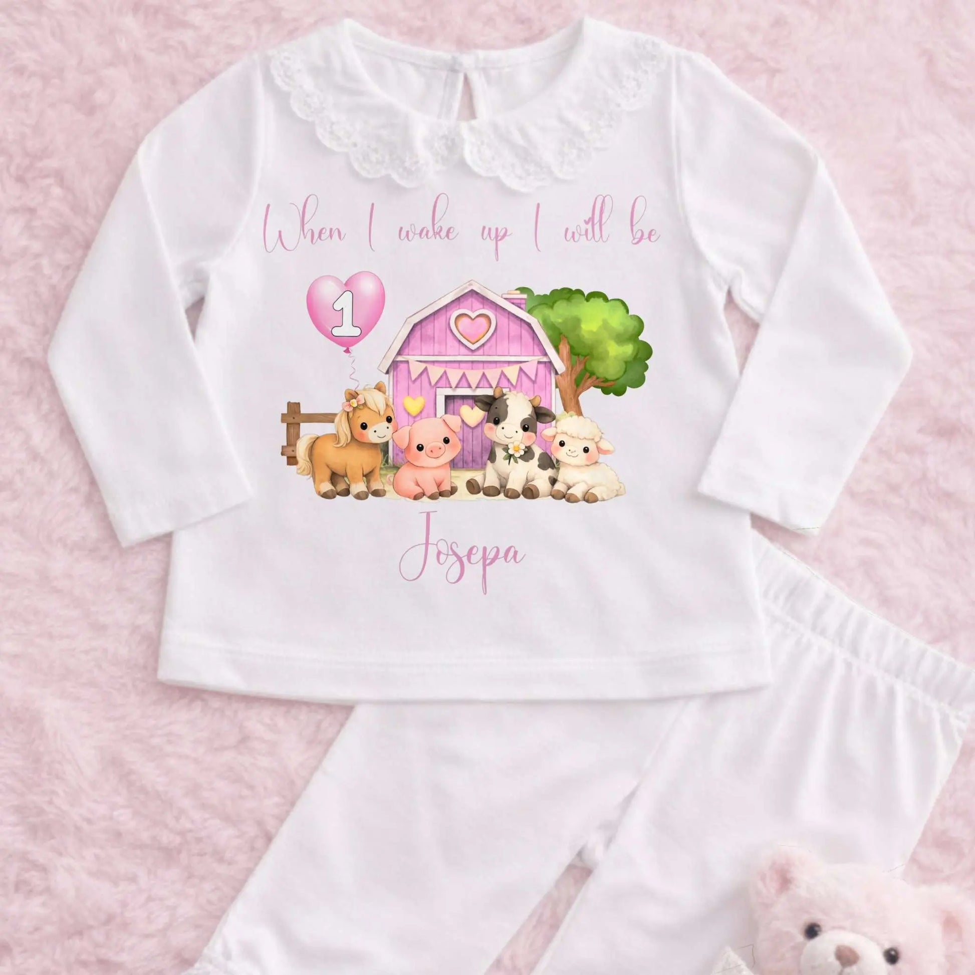 Farm Animal Birthday Pyjamas: Child wearing a white outfit with a Farm Animal Birthday Pyjamas for girls with personalised name, age balloon, cute farm animals, frilly collar and leg cuffs