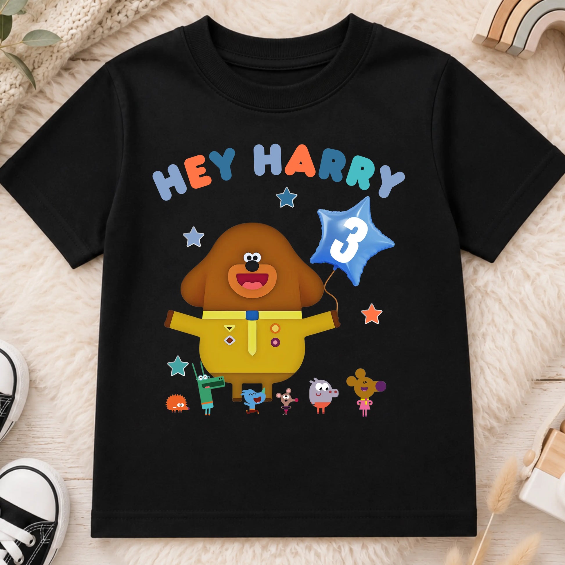 A personalised Hey Duggee kids birthday t-shirt featuring a colourful character design and the text "HEY Harry" on the front.