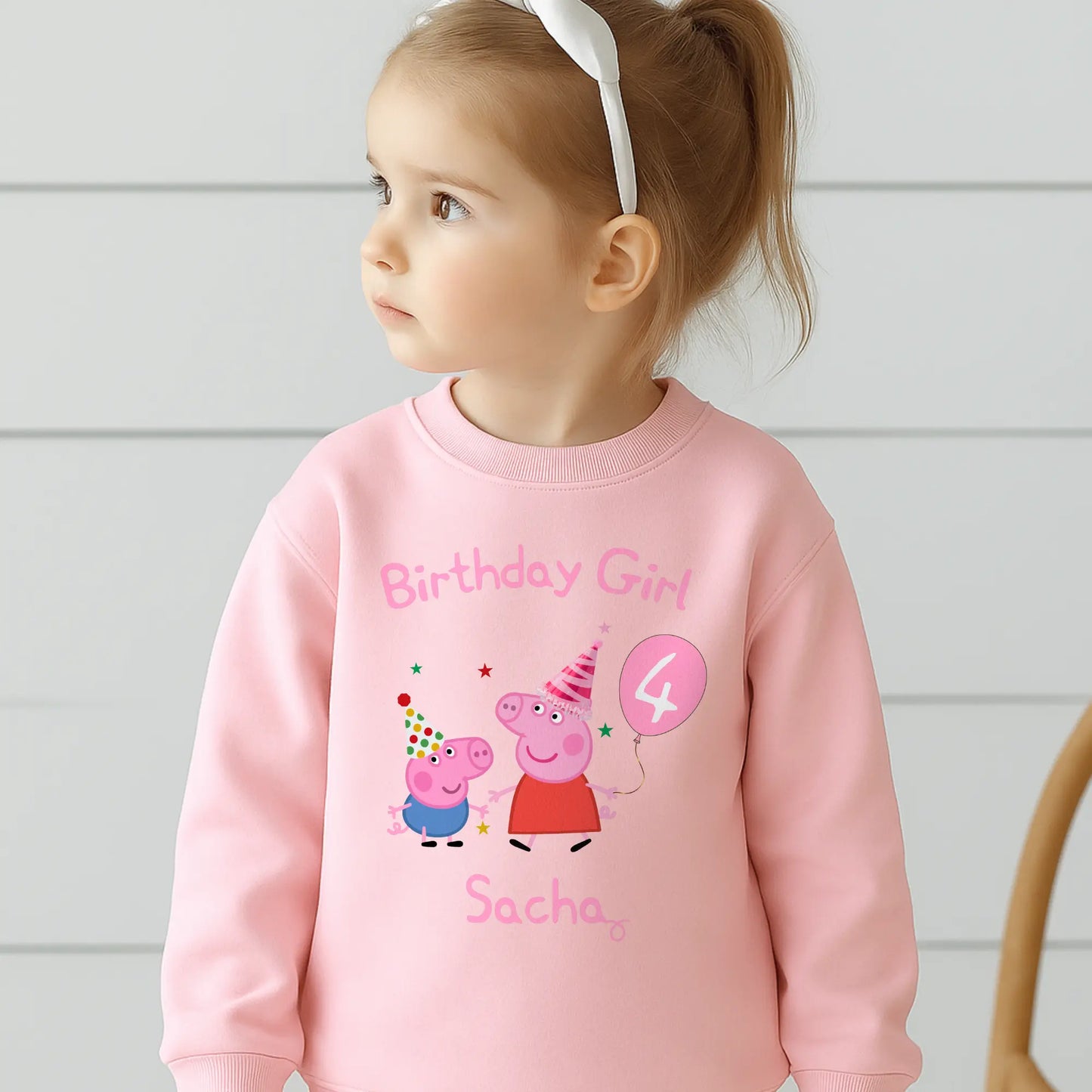Peppa and George pig birthday sweatshirt: Child wearing a personalised Peppa and George white sweatshirt with 'Birthday Girl' and her custom age and name, standing against a light background.