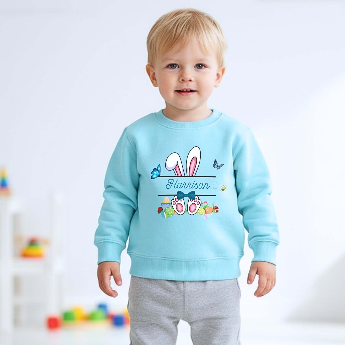 Boys Easter top with personalised split monogram bunny design, available as t-shirt or sweatshirt. Custom name Easter top