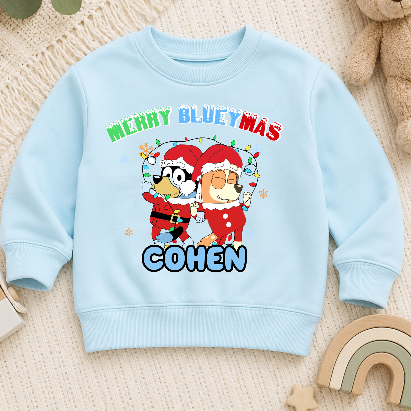 Personalised Christmas Jumper for kids featuring a festive Merry Blueymas design with Bluey and Bingo, personalised with your child's name.