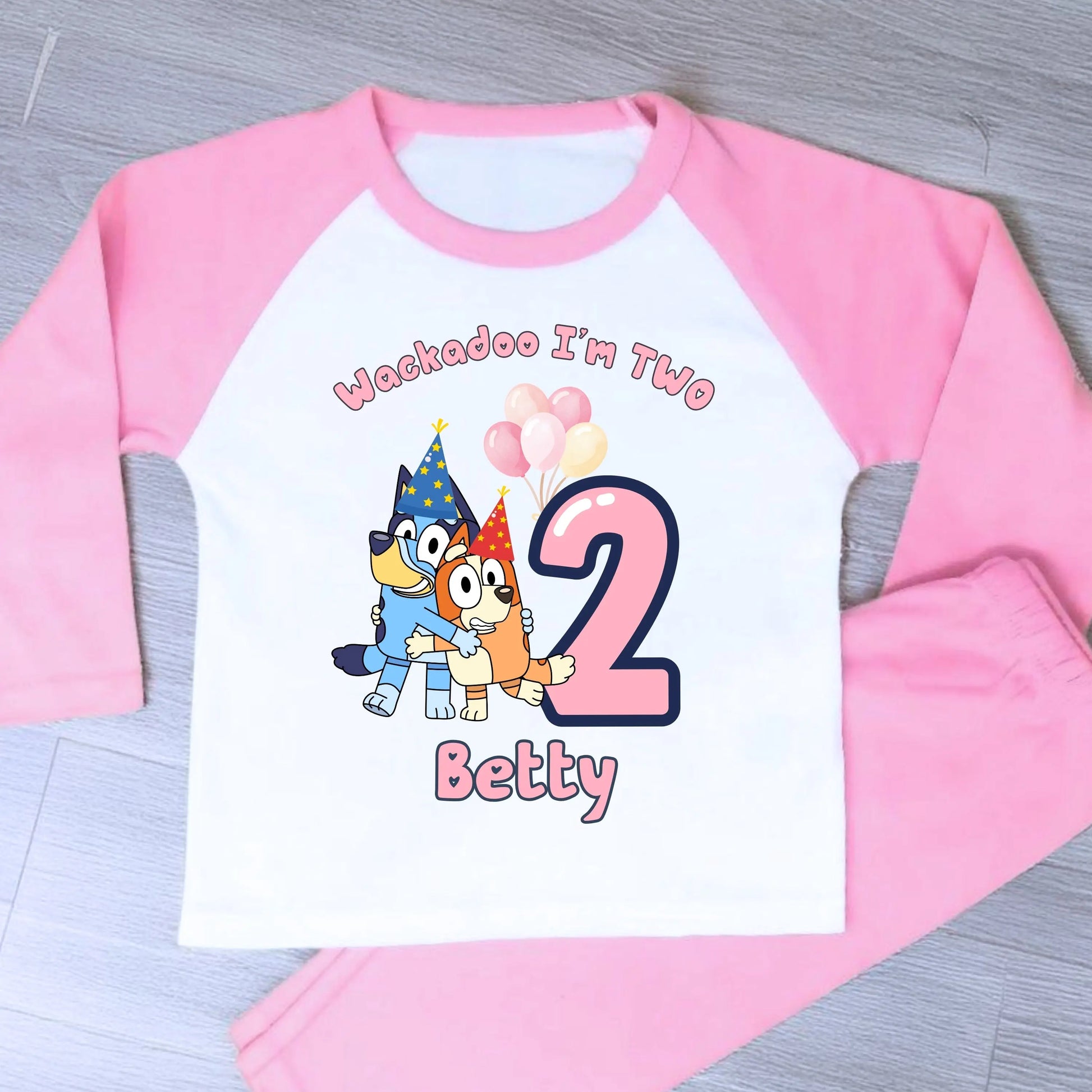 Bluey and Bingo Birthday Pyjamas for Girls with custom name and age in a pink party-themed design.