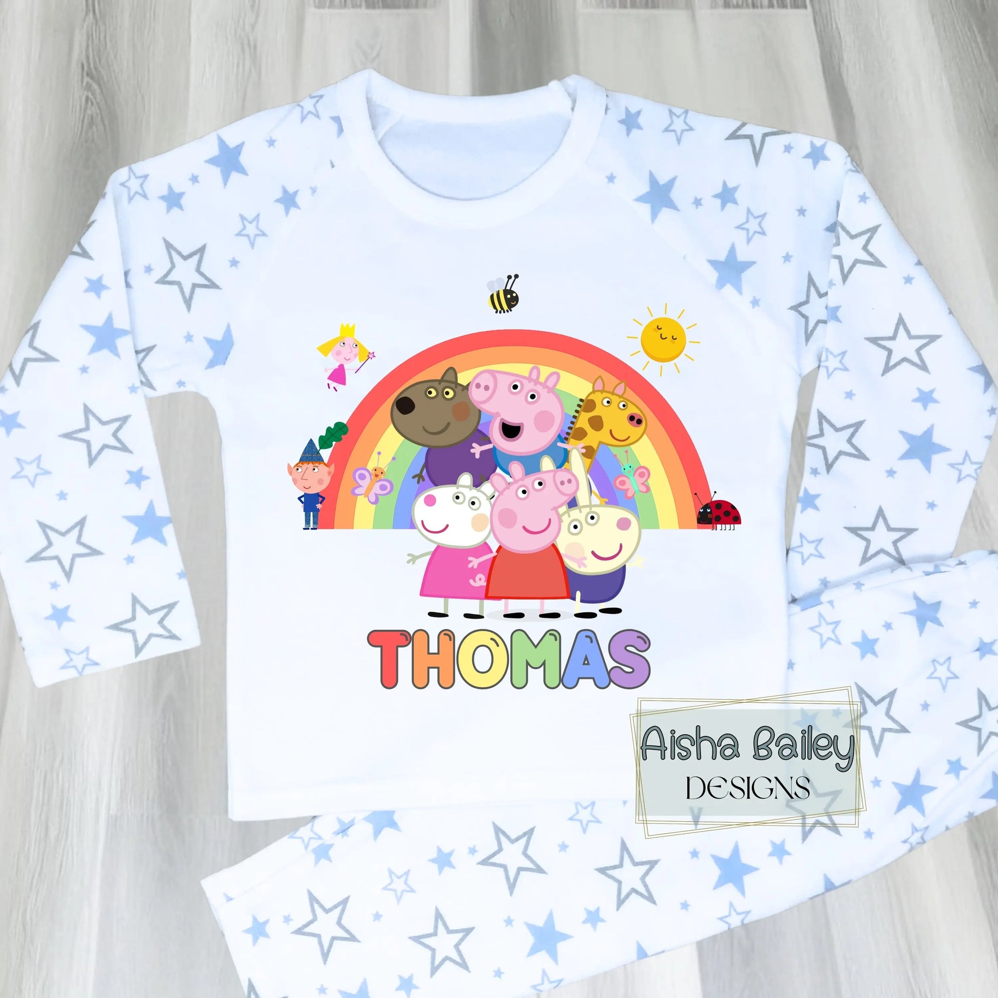 Blue Peppa Pig personalised boys pyjamas set featuring a colourful rainbow design and favourite Peppa Pig characters, customised with name and age. Made from soft, comfortable fabric with a long-sleeve top and matching cloud-print bottoms. Perfect for everyday wear, cosy nights, and relaxed mornings—ideal personalised Peppa Pig sleepwear for toddlers and young children.