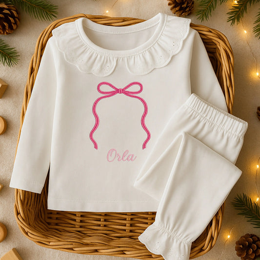 Personalised bow pyjamas for girls with embroidered bow and name on soft white sleepwear