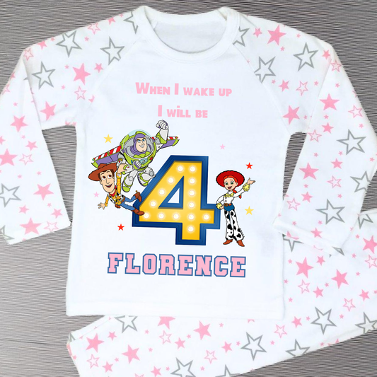 Toy Story birthday pyjamas for girls with custom name and age, featuring Buzz Lightyear, Woody, and Jessie, bold birthday number in Toy Story colours, and name printed underneath, soft and comfy sleepwear set for birthday mornings