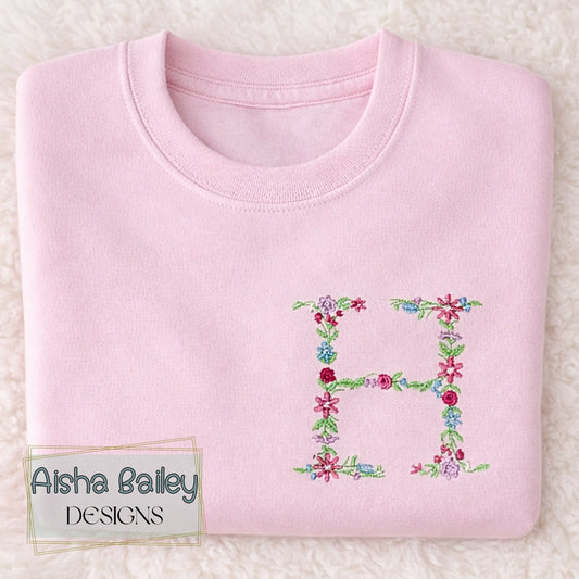 Floral initial embroidered sweatshirt: Floral initial girls sweatshirt featuring delicate embroidered flower letter design on soft kids jumper.
