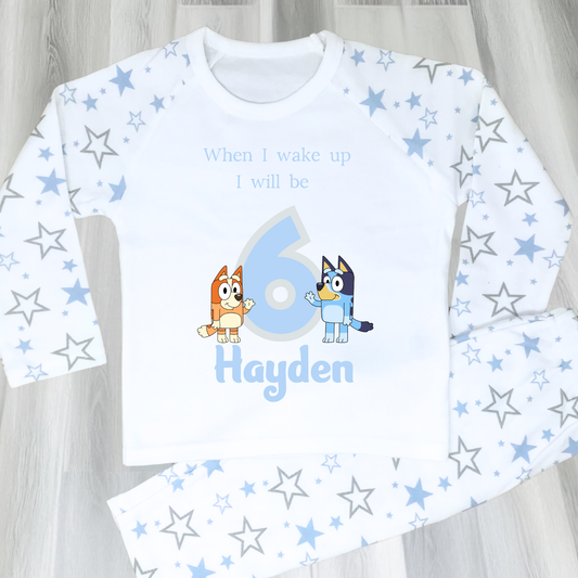 Personalised Bluey and Bingo birthday pujamas featuring vibrant prints of the beloved characters and a number to indicate the child's age. These delightful pyjamas, complete with the child's name, make bedtime an exciting continuation of the birthday festivities. Perfect for creating cherished birthday traditions and adding joy to the special day. Bluey pyjamas, Bingo pyjamas, birthday pyjamas, personalised children's pyjamas, birthday celebration, bedtime fun, toddler birthday