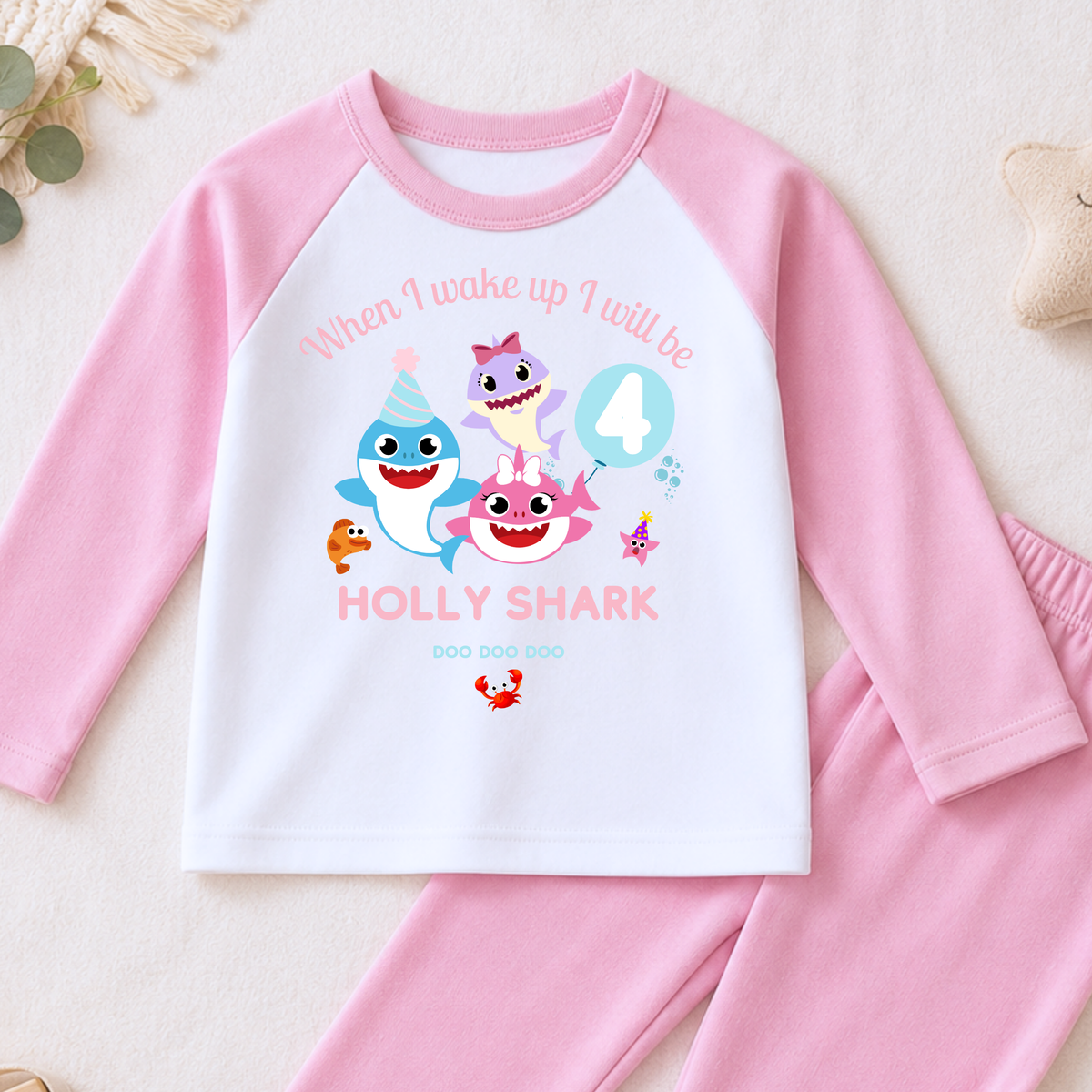 Personalised Baby Shark Birthday Pyjamas for Girls, white long sleeve PJs with pink and blue shark design, birthday age and custom name