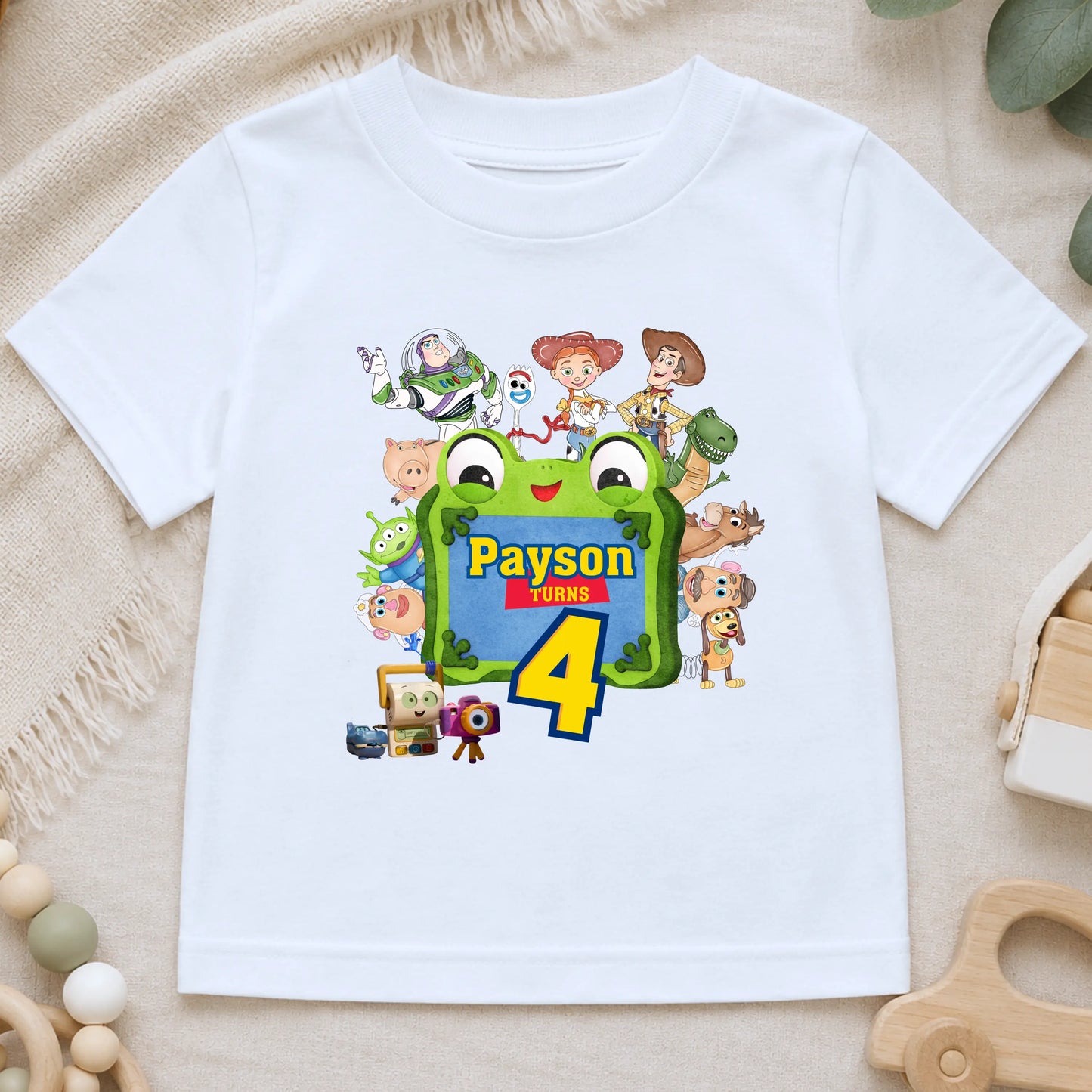 Personalised Toy Story birthday T-shirt for boys featuring custom name and age with colourful Toy Story-inspired characters including Buzz, Woody and friends, perfect for a birthday party outfit, cake smash and birthday photos.
