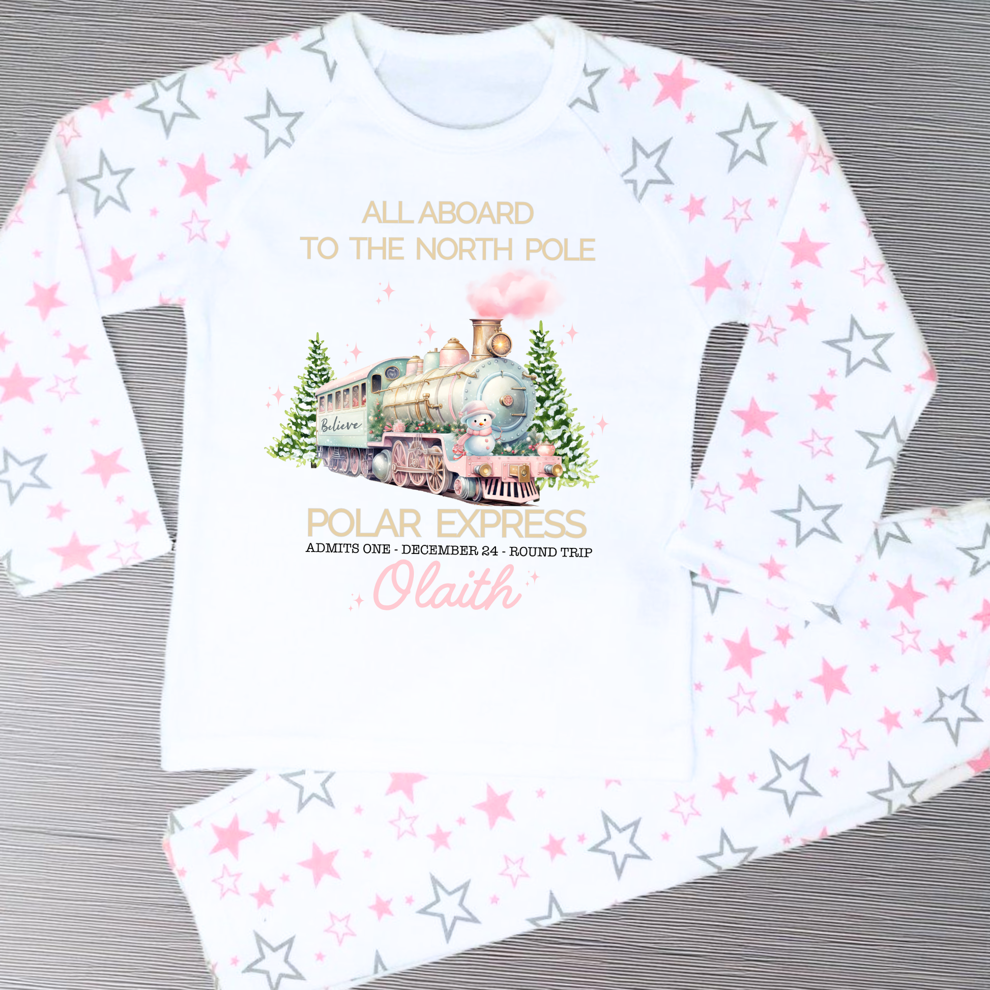 Polar express christmas pyjamas: A set of pink polar express Christmas Eve pyjamas for girls, personalised with a name. These pyjamas are designed to evoke the magic and wonder of the holiday season, made from soft, breathable fabric for a cozy night's sleep. Perfect for dreaming of a Polar Express journey to the North Pole. Girls polar express christmas pjs, christmas pyjamas personalised