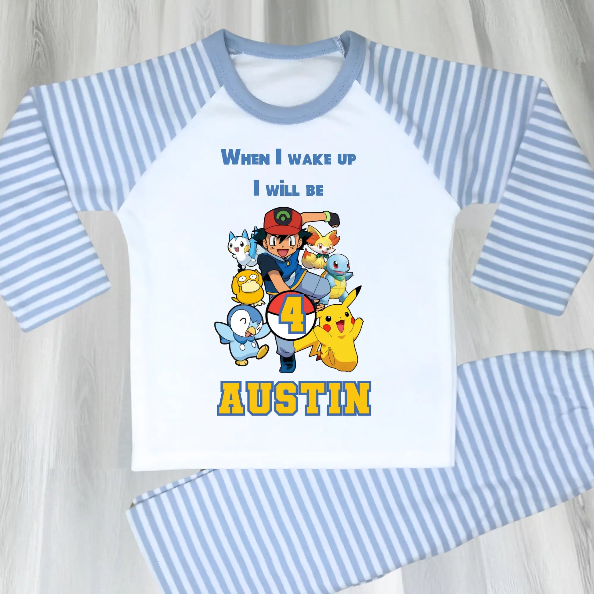 Pokomon birthday pyjamas: Children's PJst with Pokomon characters and text on a light blue and white background