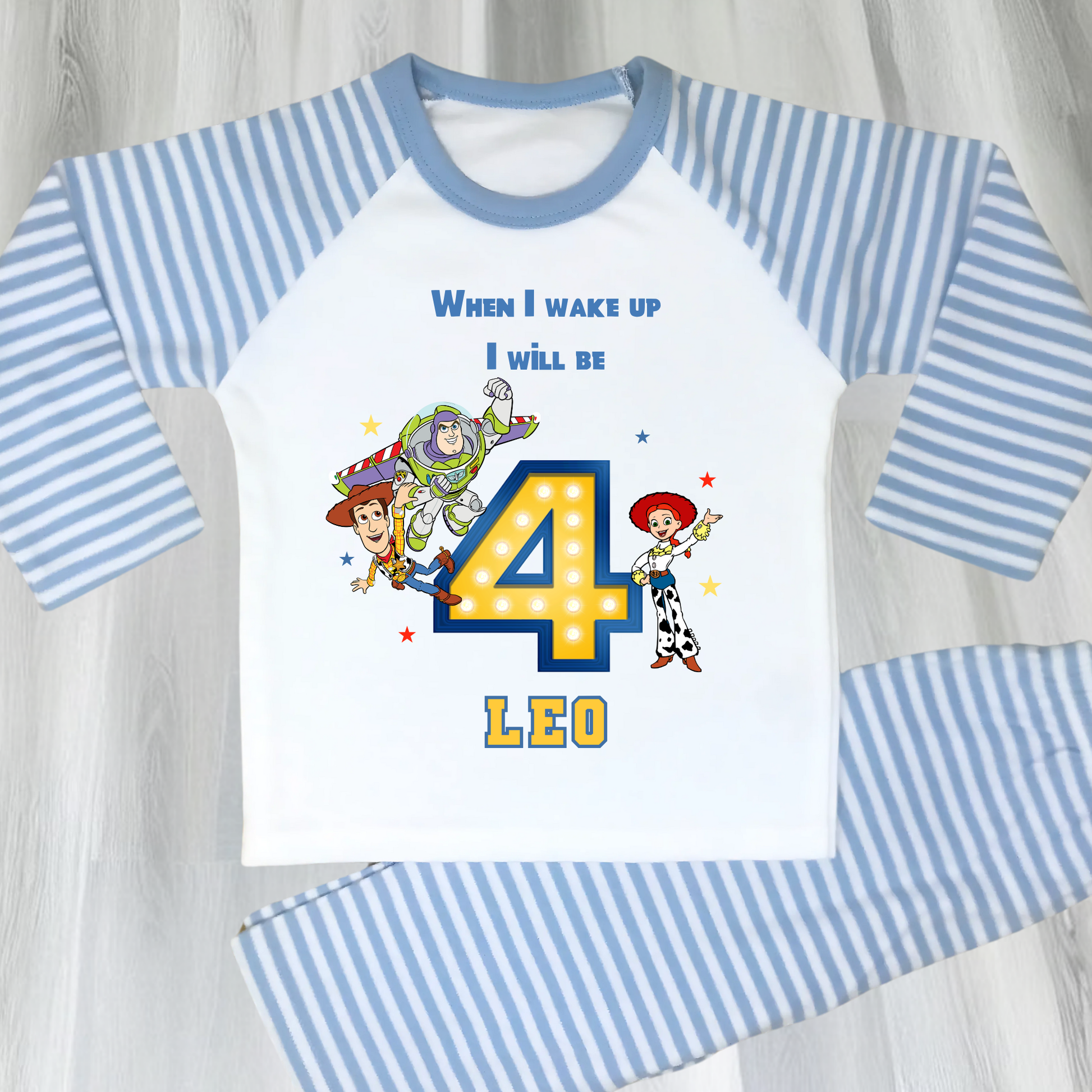Toy Story birthday pyjamas for boys with custom name and age, featuring Buzz Lightyear, Woody, and Jessie, bold birthday number in Toy Story colours, and name printed underneath, soft and comfy sleepwear set for birthday mornings