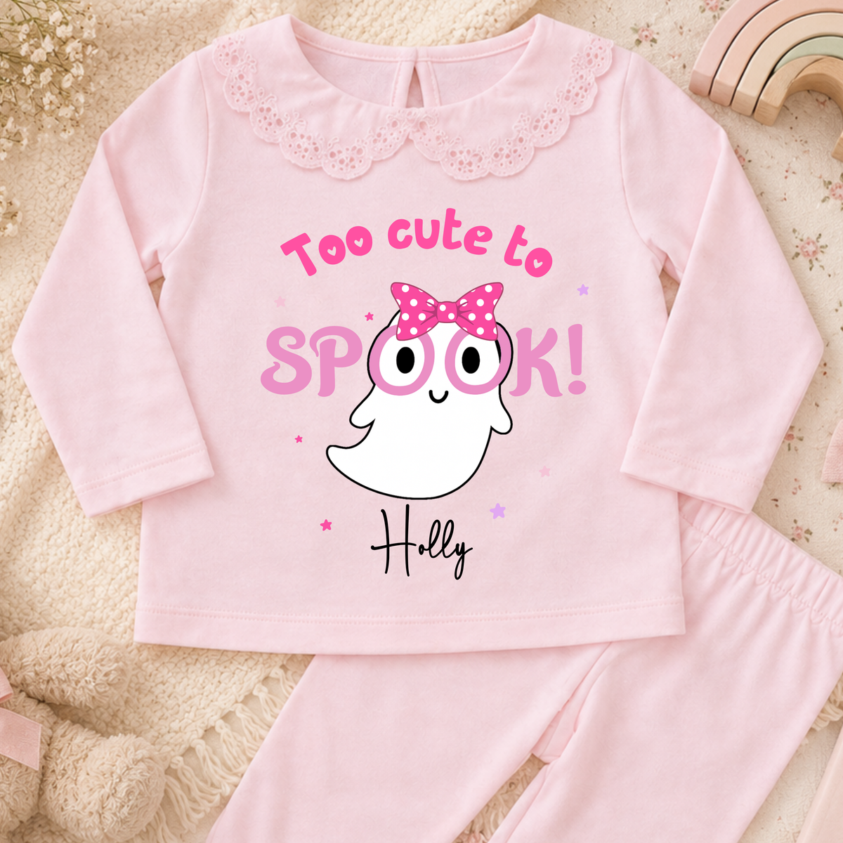 Personalised Halloween Pyjamas for Girls with cute pink ghost design, custom name, long sleeves and pretty frill details for spooky season.