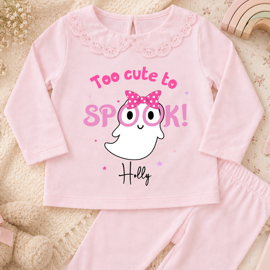 Personalised Halloween Pyjamas for Girls with cute pink ghost design, custom name, long sleeves and pretty frill details for spooky season.