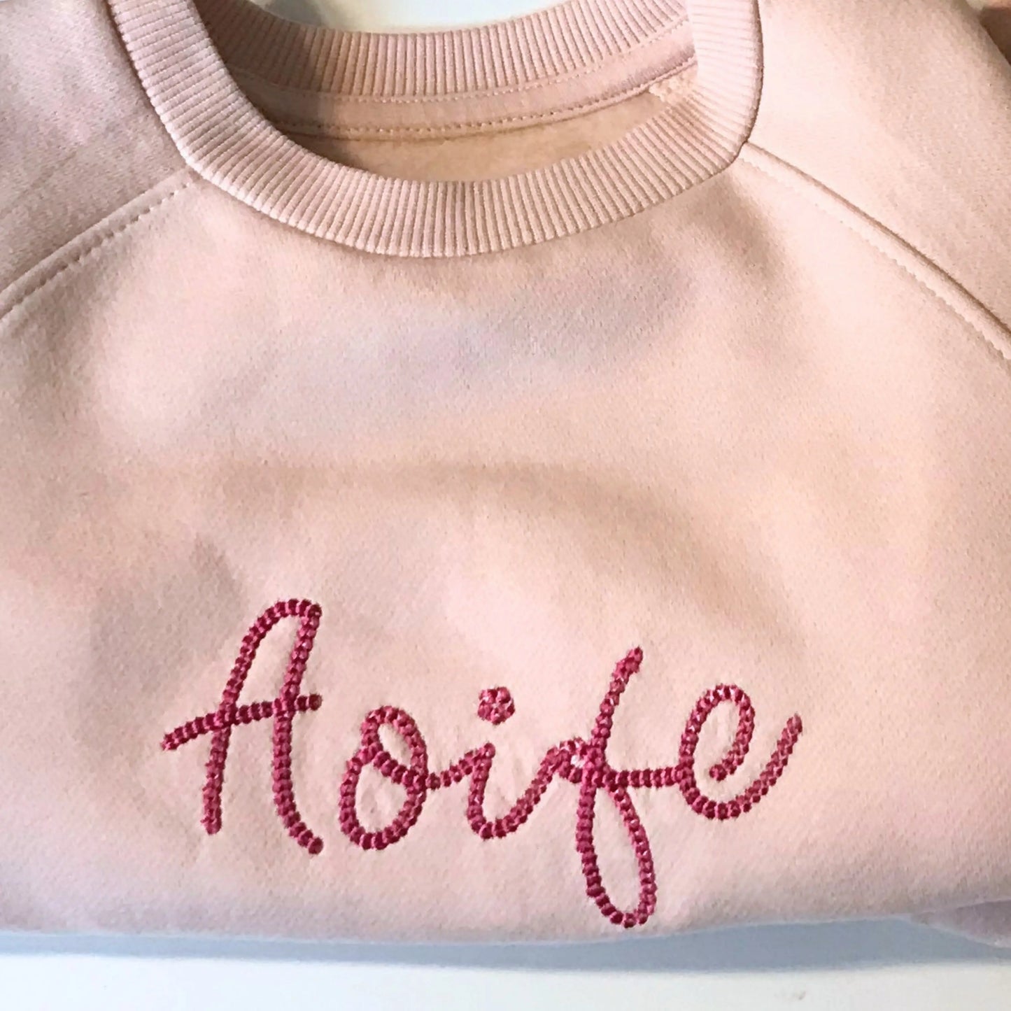 Personalised embroidered loungewear with a name: A child wearing a loungewear set with their name displayed on the front. Perfect for Christmas and birthday gifting