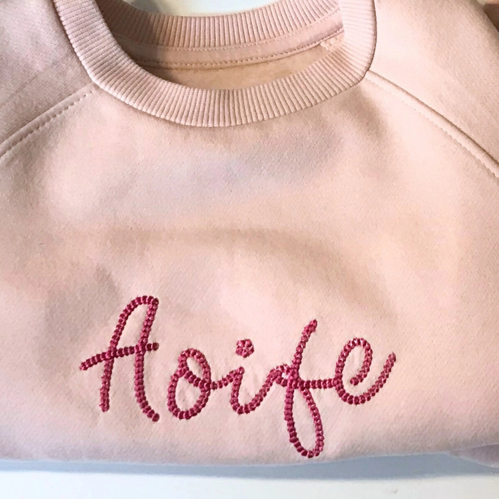 Personalised embroidered loungewear with a name: A child wearing a loungewear set with their name displayed on the front. Perfect for Christmas and birthday gifting