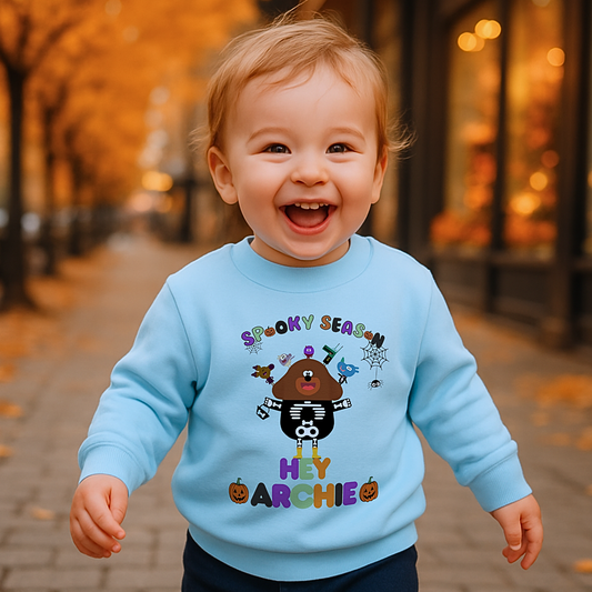 Child wearing personalised Halloween sweatshirt with trick-or-treat, Spooky Season design and custom name custom name