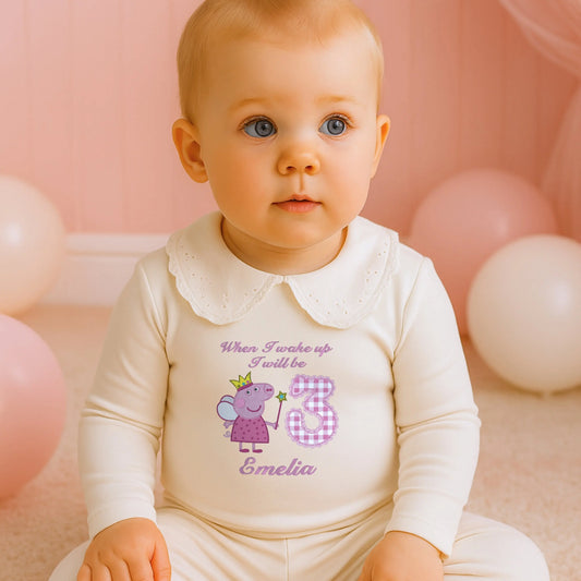 Embroidered Peppa Pig Pyjamas: A child wearing white frilly pyjamas with a Peppa Pig design with child's name under. Perfect for Christmas and birthday gifting.