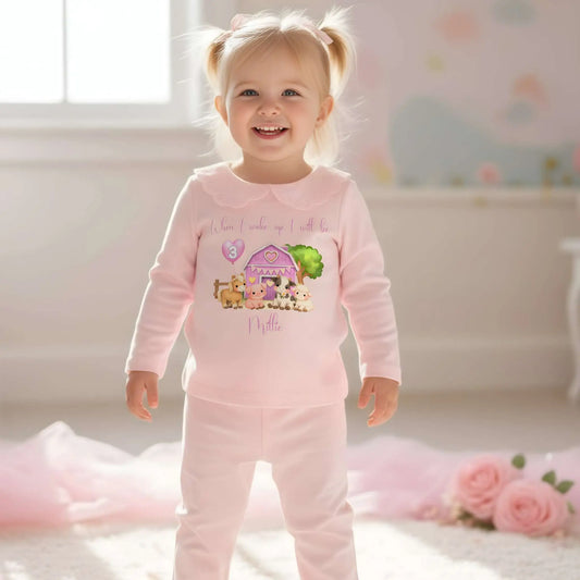 Farm Animal Birthday Pyjamas: Child wearing a white outfit with a Farm Animal Birthday Pyjamas for girls with personalised name, age balloon, cute farm animals, frilly collar and leg cuffs