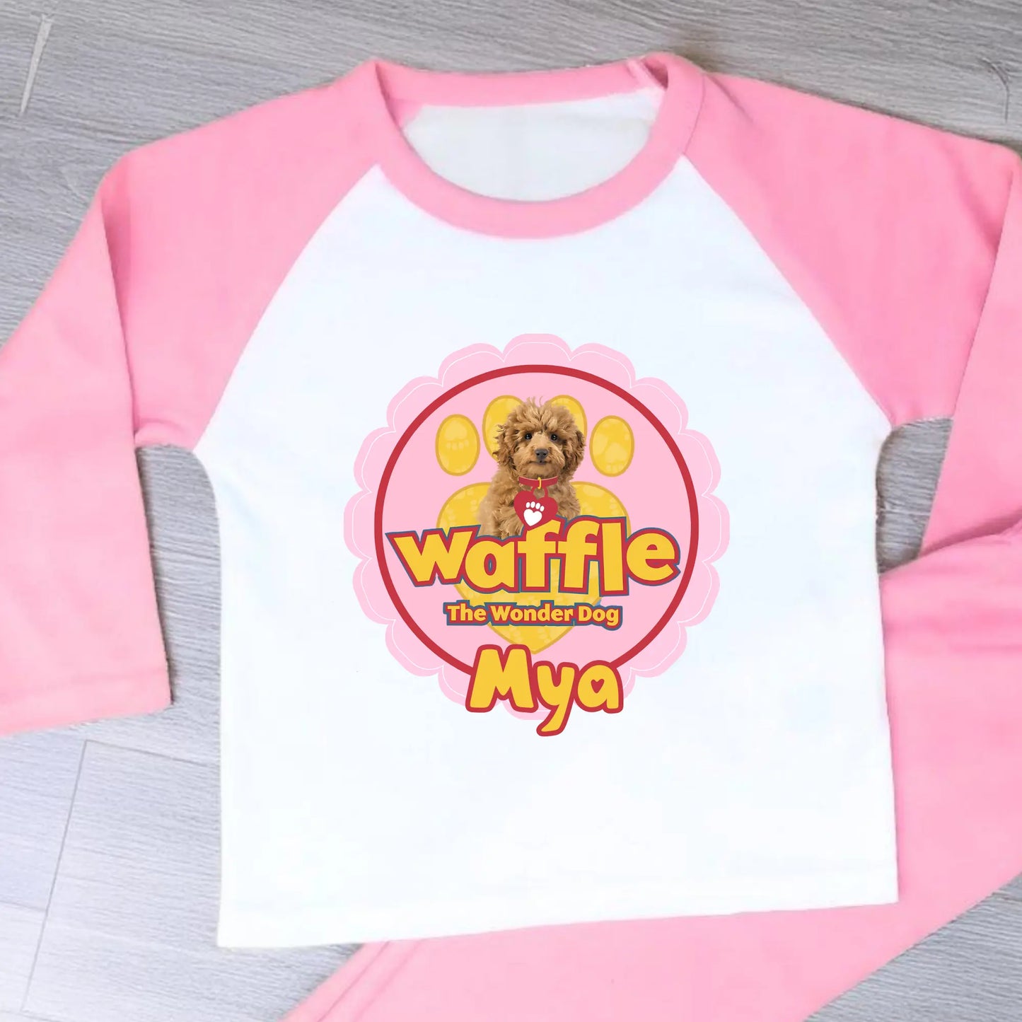 Personalised Waffle Pyjamas: Children's long-sleeve pyjamas with personalised Waffle the Wonder Dog design on a star-patterned background, custom name pyjamas