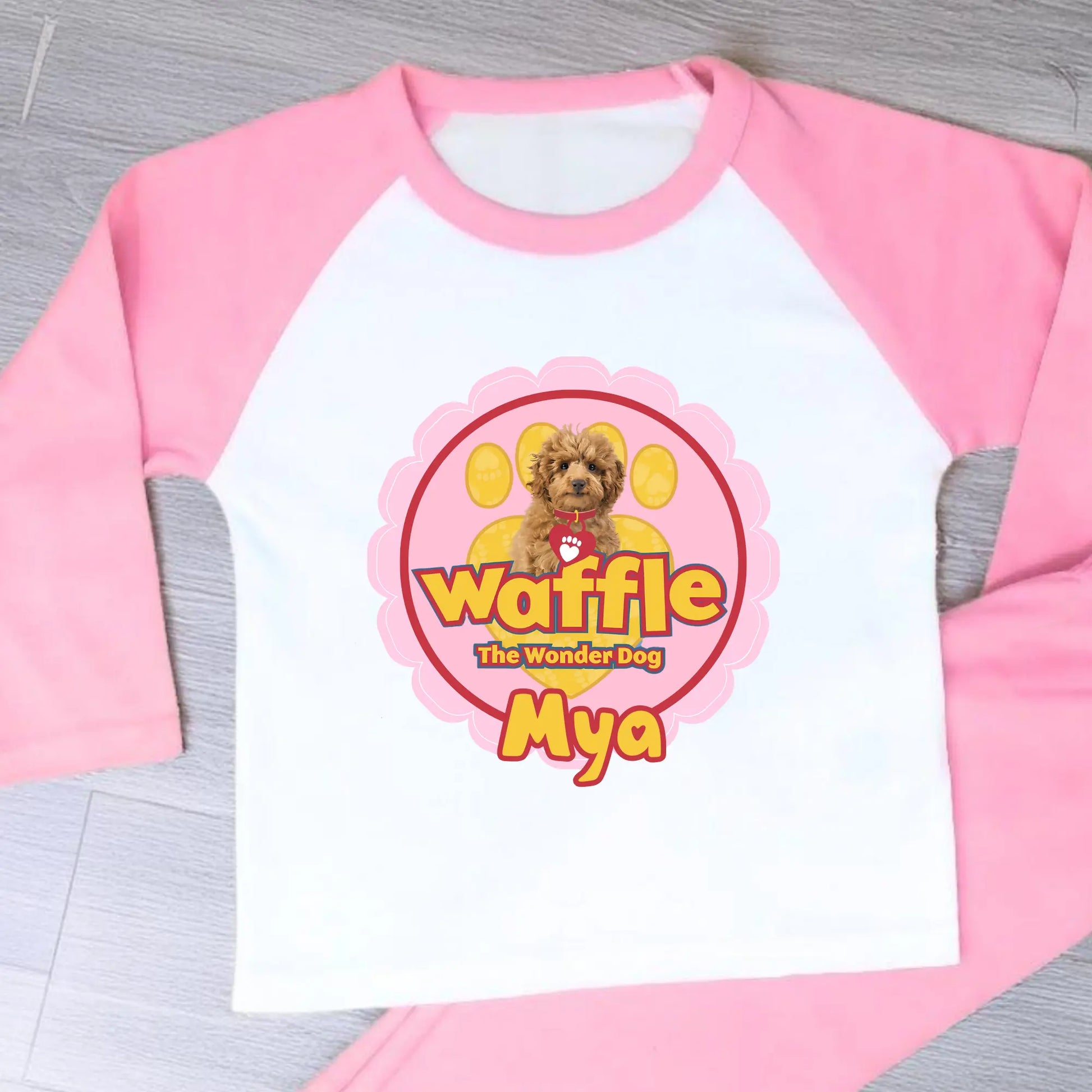 Personalised Waffle Pyjamas: Children's long-sleeve pyjamas with personalised Waffle the Wonder Dog design on a star-patterned background, custom name pyjamas