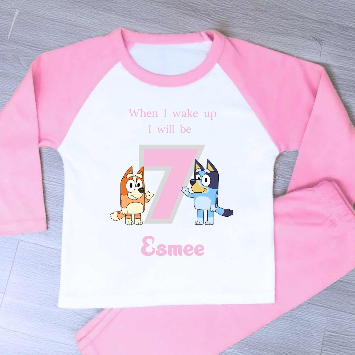 Bluey Birthday Pyjamas - Personalised Bluey and Bingo birthday pyjamas featuring vibrant prints of the beloved characters and a number to indicate the child's age. These delightful pyjamas, complete with the child's name, make bedtime an exciting continuation of the birthday festivities. Perfect for creating cherished birthday traditions and adding joy to the special day. Bluey pyjamas, Bingo pyjamas, birthday pyjamas, personalised children's pyjamas, birthday celebration, bedtime fun, toddler birthday