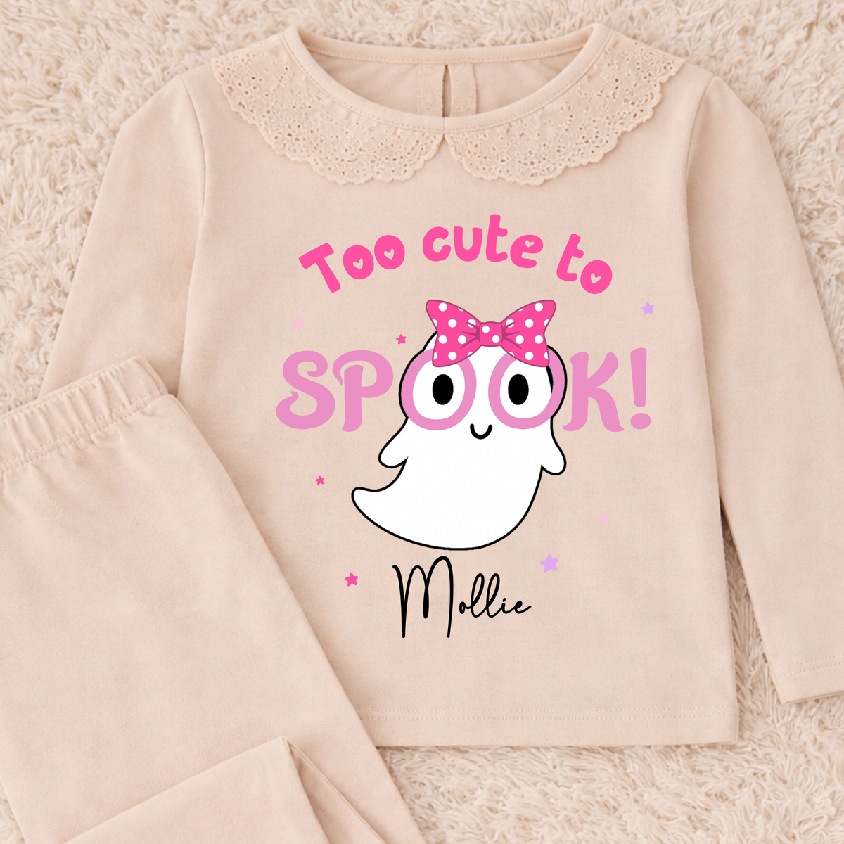 Personalised Halloween Pyjamas for Girls with cute pink ghost design, custom name, long sleeves and pretty frill details for spooky season.