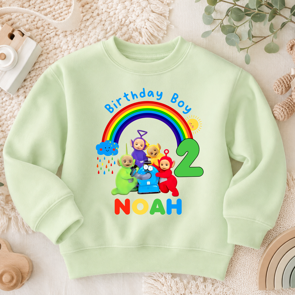 Personalised Boys Teletubbies Birthday Sweatshirt with rainbow design, custom name and age, available in white, blue and green.