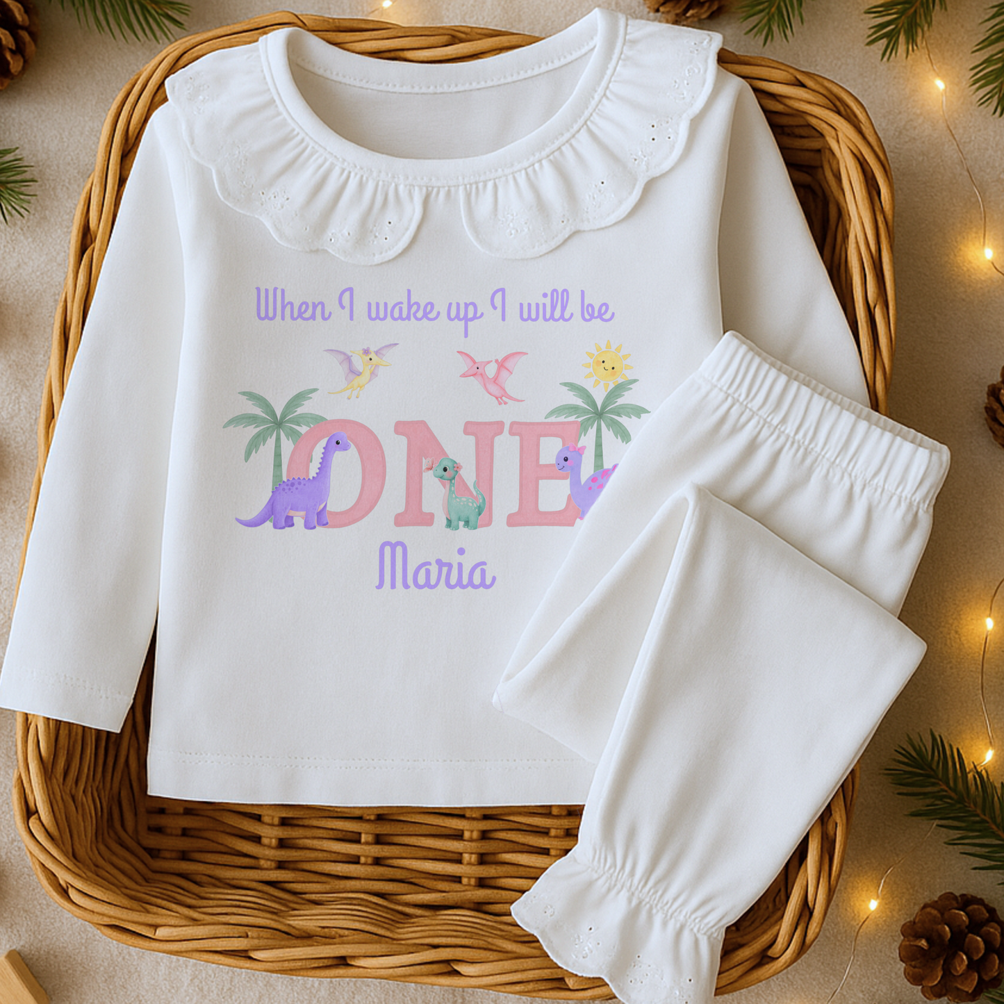 Girls dinosaur birthday pyjamas personalised with name and age featuring pastel dinosaurs and palm trees with custom name