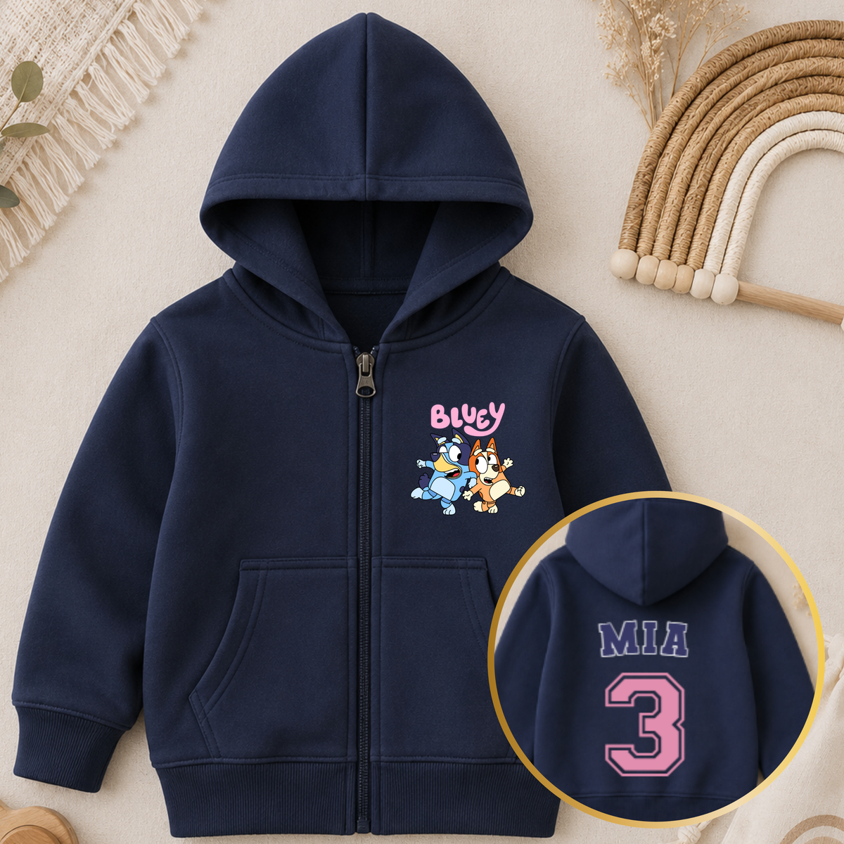 Personalised Girls Birthday Hoodie featuring Bluey and Bingo on the front, with your child's name and birthday age in a pink varsity-style design on the back.