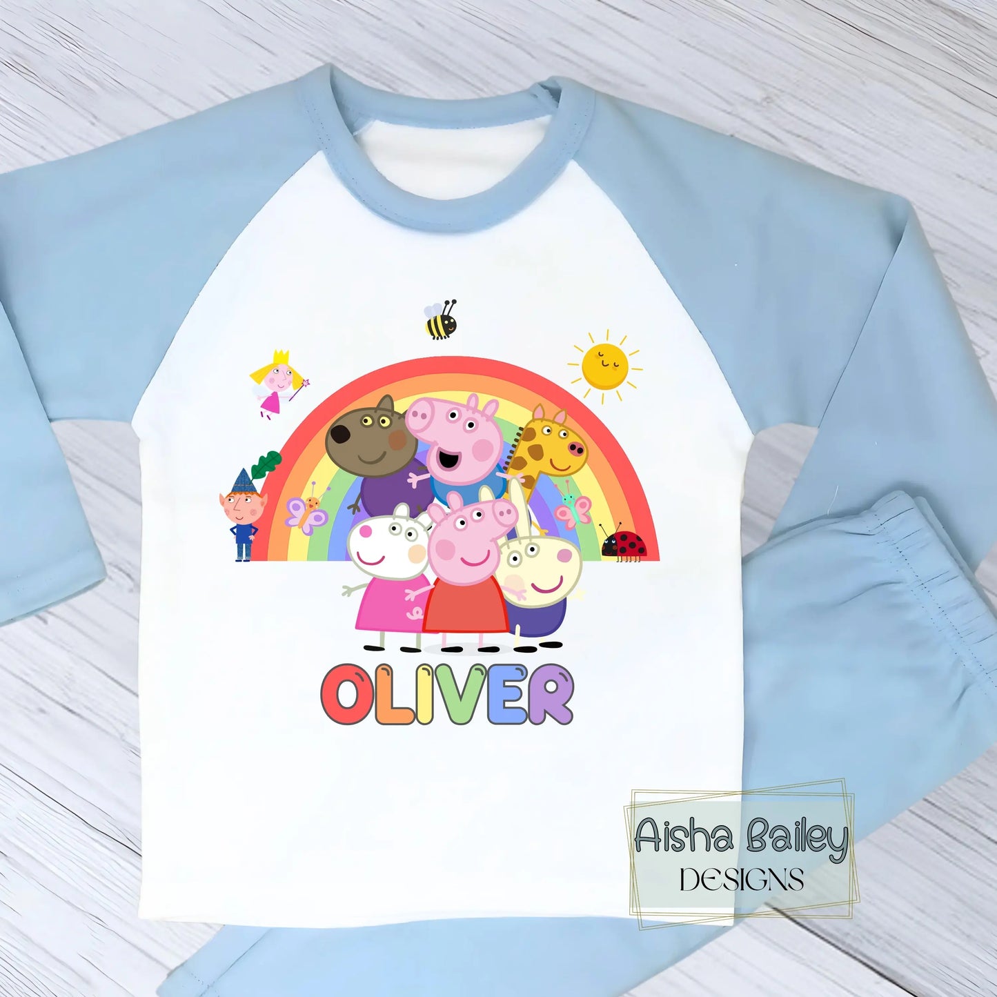 Blue Peppa Pig personalised boys pyjamas set featuring a colourful rainbow design and favourite Peppa Pig characters, customised with name and age. Made from soft, comfortable fabric with a long-sleeve top and matching cloud-print bottoms. Perfect for everyday wear, cosy nights, and relaxed mornings—ideal personalised Peppa Pig sleepwear for toddlers and young children.