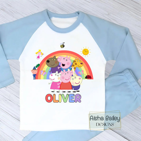 Blue Peppa Pig personalised boys pyjamas set featuring a colourful rainbow design and favourite Peppa Pig characters, customised with name and age. Made from soft, comfortable fabric with a long-sleeve top and matching cloud-print bottoms. Perfect for everyday wear, cosy nights, and relaxed mornings—ideal personalised Peppa Pig sleepwear for toddlers and young children.