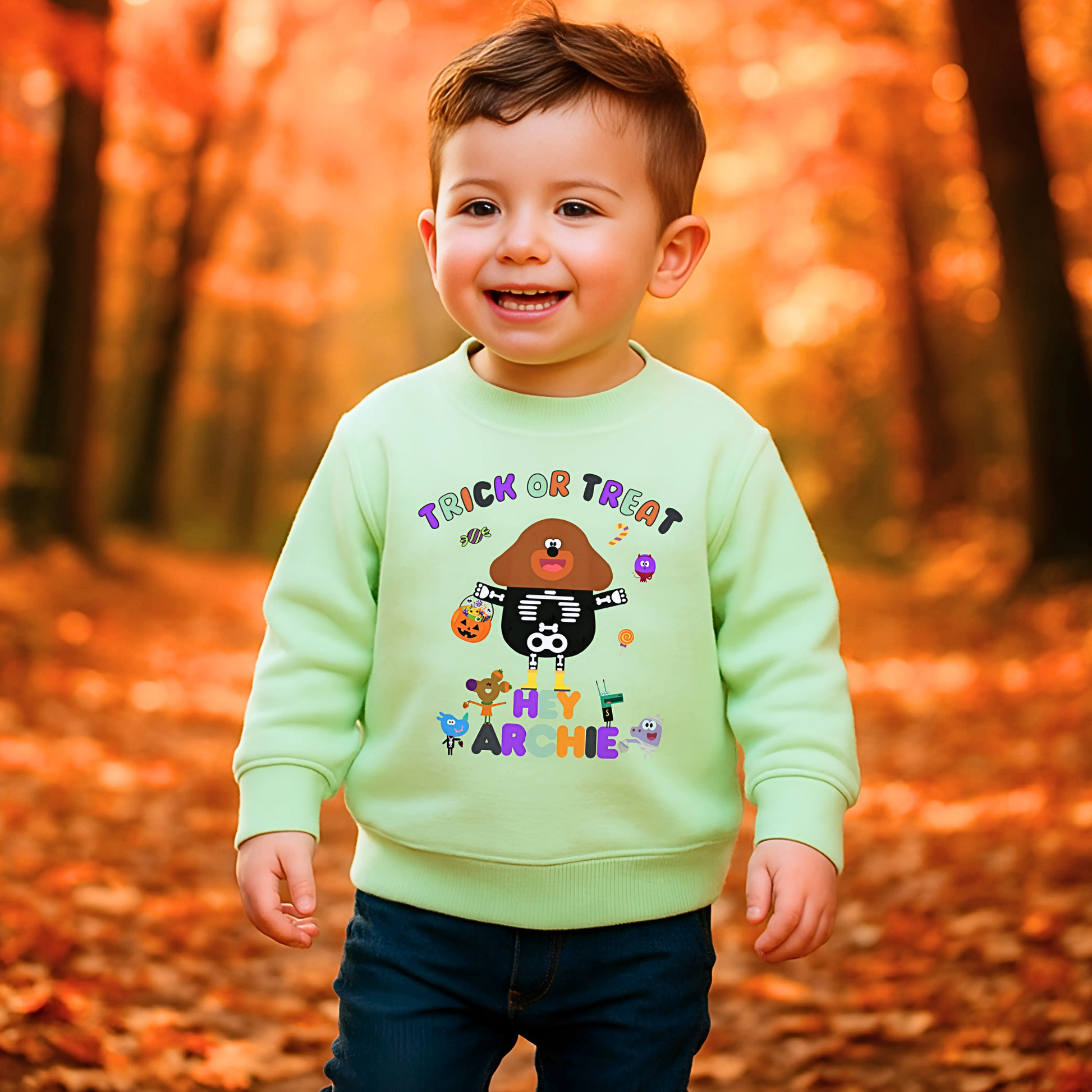 Child wearing personalised Halloween sweatshirt with trick-or-treat hey Duggee design and custom name