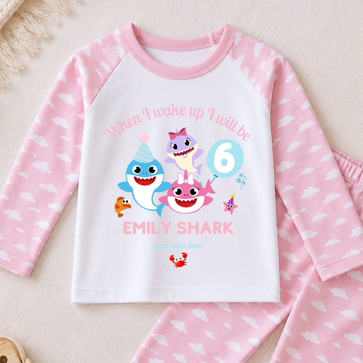 Personalised Baby Shark Birthday Pyjamas for Girls, white long sleeve PJs with pink and blue shark design, birthday age and custom name