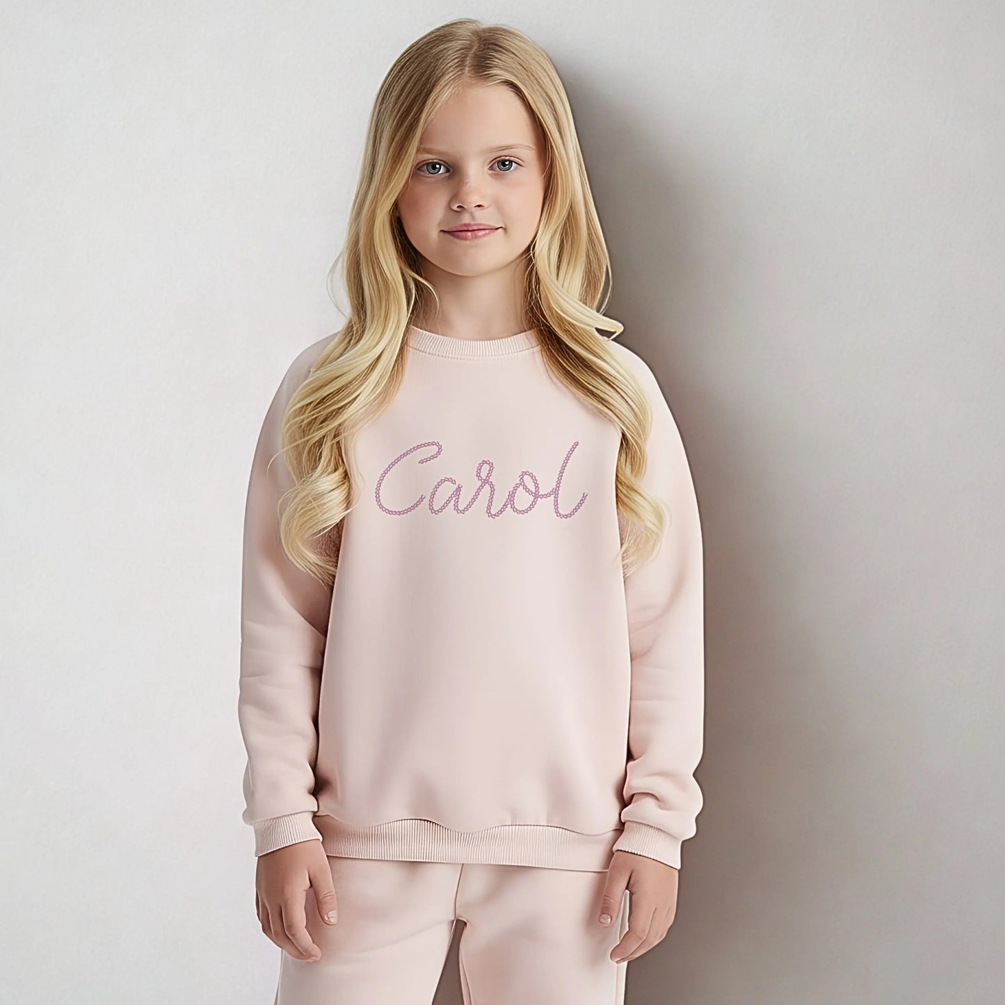 Personalised embroidered loungewear with a name: A child wearing a loungewear set with their name displayed on the front. Perfect for Christmas and birthday gifting