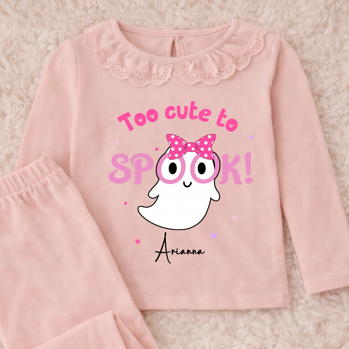 Personalised Halloween Pyjamas for Girls with cute pink ghost design, custom name, long sleeves and pretty frill details for spooky season.