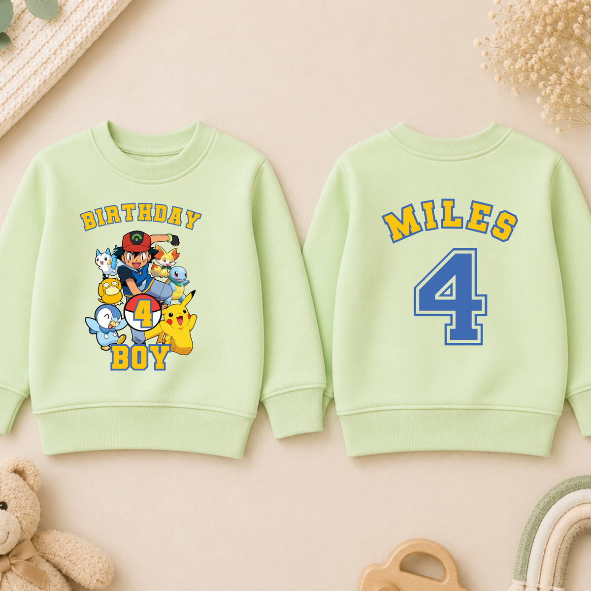Personalised Pokémon Birthday Sweatshirt for Boys, white gamer jumper with colourful Pokemon characters, birthday age and custom name on back.