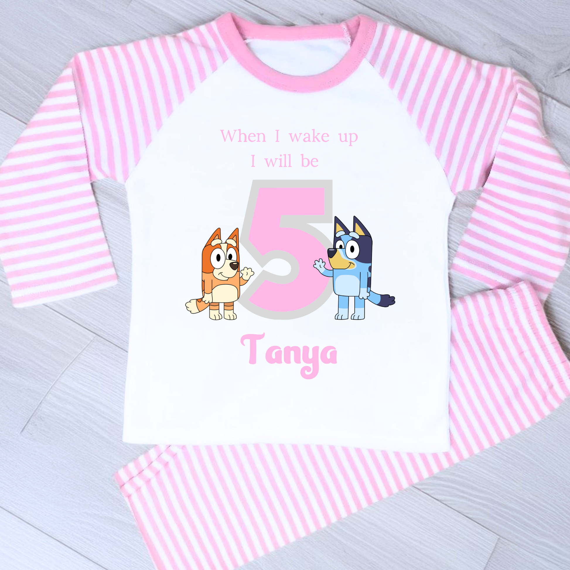 Bluey Birthday Pyjamas - Personalised Bluey and Bingo birthday pyjamas featuring vibrant prints of the beloved characters and a number to indicate the child's age. These delightful pyjamas, complete with the child's name, make bedtime an exciting continuation of the birthday festivities. Perfect for creating cherished birthday traditions and adding joy to the special day. Bluey pyjamas, Bingo pyjamas, birthday pyjamas, personalised children's pyjamas, birthday celebration, bedtime fun, toddler birthday