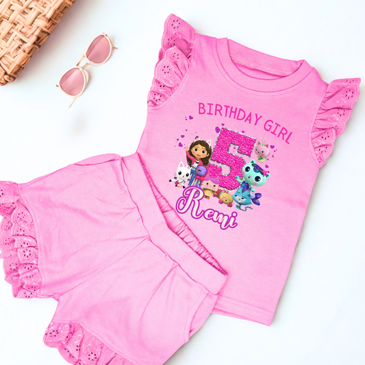 Gabby's dollhouse birthday outfit, An adorable personalised birthday outfit inspired by Gabbie's Dollhouse, featuring a frilly top and matching shorts. The ensemble can be customised with any name and age, making it perfect for a special birthday celebration. Perfect birthday gift for girls, personalised summer outfit