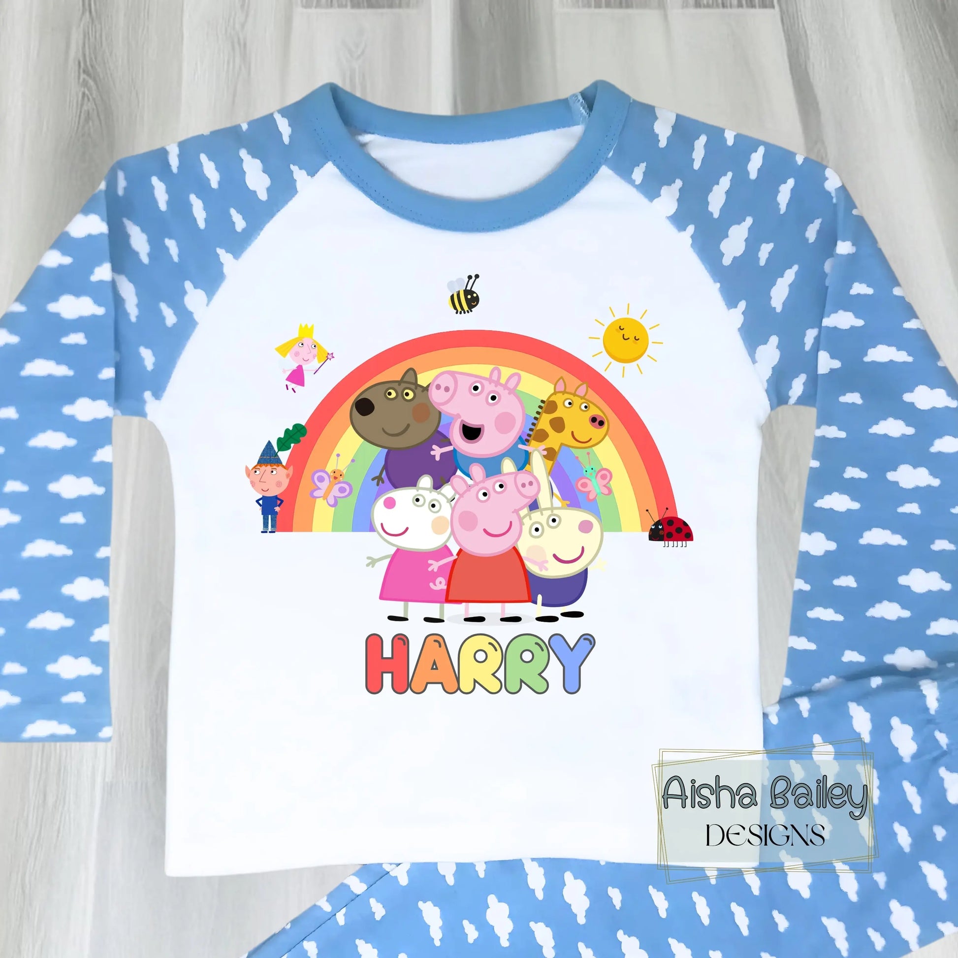Blue Peppa Pig personalised boys pyjamas set featuring a colourful rainbow design and favourite Peppa Pig characters, customised with name and age. Made from soft, comfortable fabric with a long-sleeve top and matching cloud-print bottoms. Perfect for everyday wear, cosy nights, and relaxed mornings—ideal personalised Peppa Pig sleepwear for toddlers and young children.