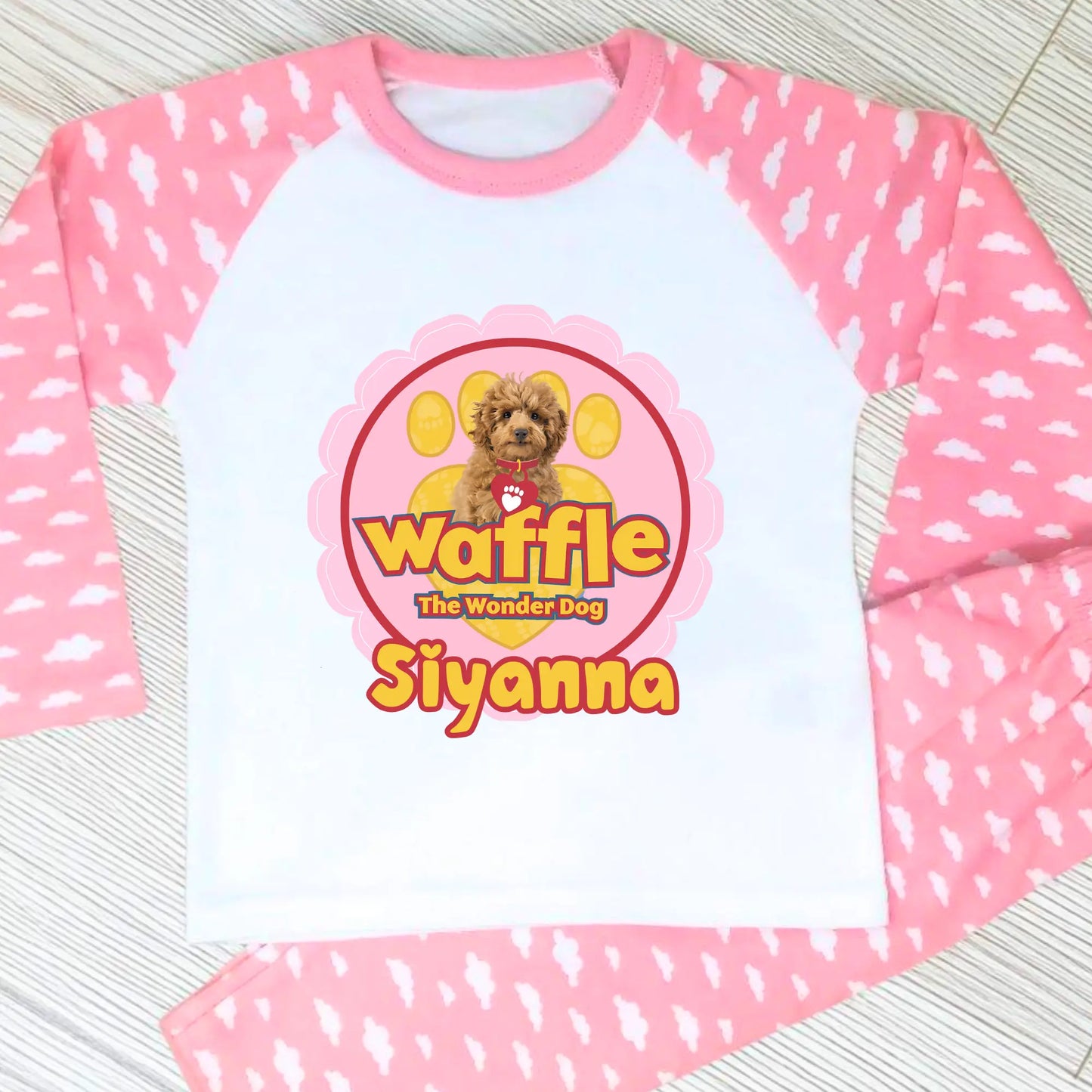 Personalised Waffle Pyjamas: Children's long-sleeve pyjamas with personalised Waffle the Wonder Dog design on a star-patterned background, custom name pyjamas