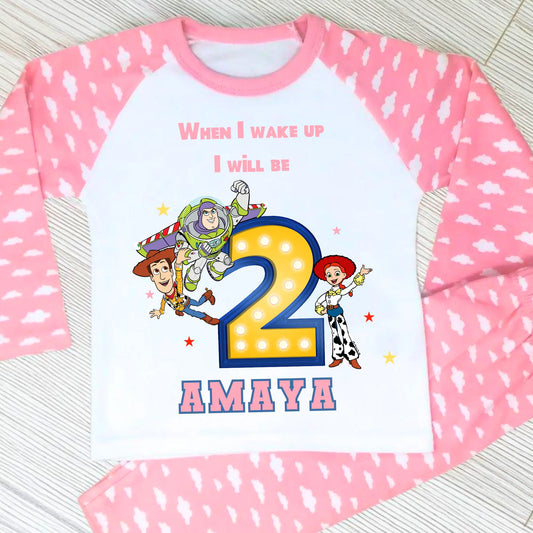 Toy Story birthday pyjamas for girls with custom name and age, featuring Buzz Lightyear, Woody, and Jessie, bold birthday number in Toy Story colours, and name printed underneath, soft and comfy sleepwear set for birthday mornings